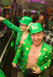 two men in shamrock suits partying at the st patricks day bar crawl