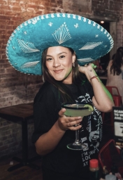 girl in sombrero celebrates cinco de mayo at the tacos and tequila bar crawl